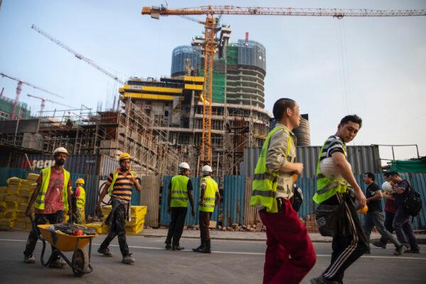 Chinese Construction workers head home after work at a new shopping mall called The Mall at One Galle Face which is part of the Chinese-managed Shangri-La retail and office complex in Colombo, Sri Lanka, on Nov. 10, 2018. (Paula Bronstein/Getty Images)