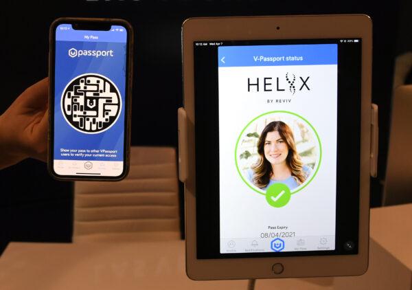 REVIV USA West Coast Operations Manager Kari Armamento uses a cell phone and an iPad to demonstrate the HELIIX Health Passport at REVIV at The Cosmopolitan of Las Vegas in Las Vegas, on April 7, 2021. (Ethan Miller/Getty Images)