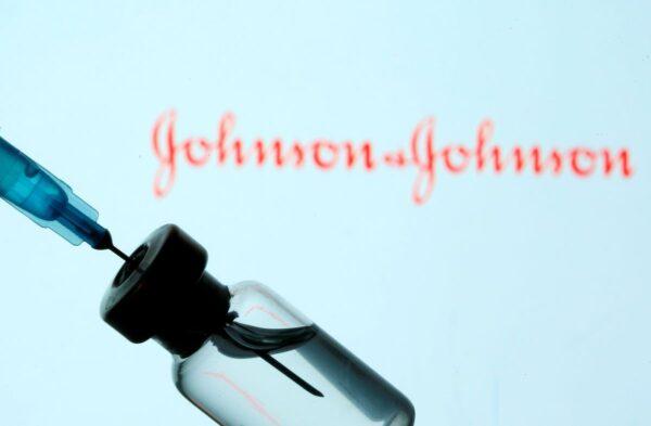 A vial and syringe are seen in front of a displayed Johnson & Johnson logo in this illustration taken Jan. 11, 2021. (Dado Ruvic/Reuters)