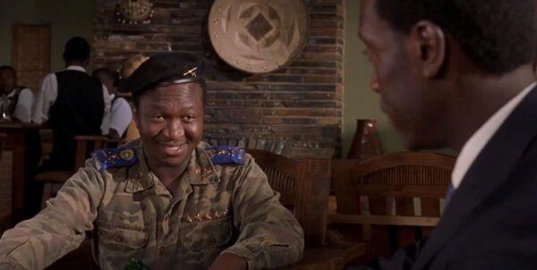 General Bizimungu (Fana Mokoena, L) negotiates with Paul Rusesabagina (Don Cheadle), who is trying to save lives. (United Artists and Lions Gate Films)