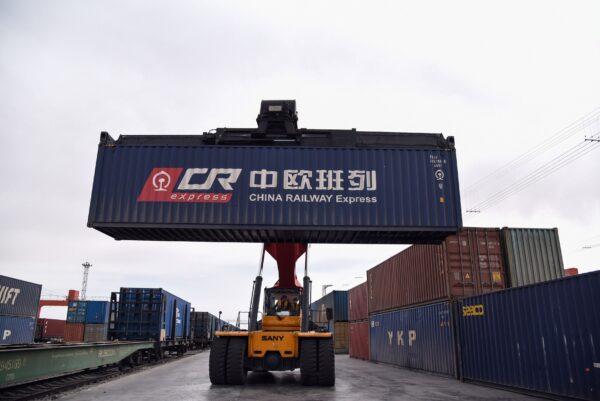 A crane transfers a container to a train of the China Railway Express to Europe in the Chinese border city of Erenhot, Inner Mongolia Region, on April 18, 2019. (STR/AFP via Getty Images)