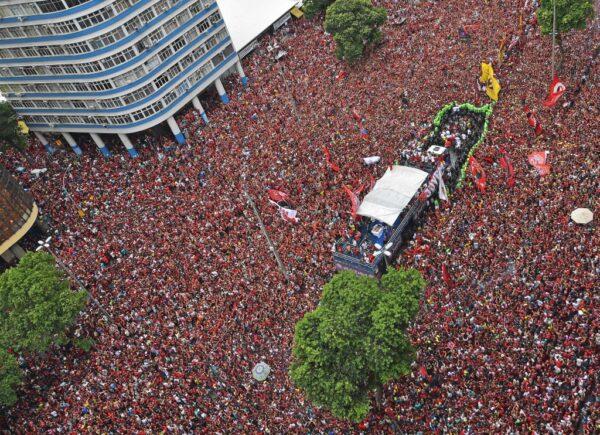 Aerial view of Brazil's Flamengo fans surrounding a bus carrying the Flamengo soccer team during a celebration parade after their Libertadores final match victory against Argentina's River Plate, in Rio de Janeiro on Nov. 24, 2019. (CARL DE SOUZA/AFP via Getty Images)