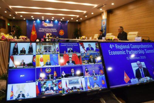 Vietnam's Prime Minister Nguyen Xuan Phuc is pictured on the screen (R) as he addresses his counterparts during the 4th Regional Comprehensive Economic Partnership (RCEP) Summit at the Association of Southeast Asian Nations (ASEAN) summit being held online in Hanoi, Vietnam on Nov. 15, 2020. (Nhac Nguyen/AFP via Getty Images)