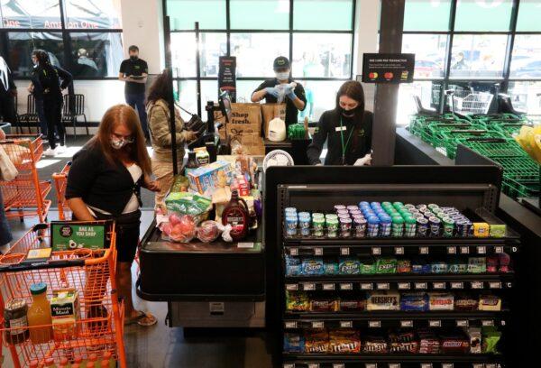 A traditional cashier checkout is an option for customers at the first Amazon Fresh in Washington that also has a cashierless technology option too, seen on opening day, in Bellevue, Wash., on June 17, 2021. (Ken Lambert/Seattle Times/TNS)