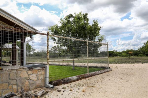 Archie McFadin replaced his fence and added razor wire after his property was continually broken into by illegal aliens, in Uvalde, Texas, on June 30, 2021. (Charlotte Cuthbertson/The Epoch Times)