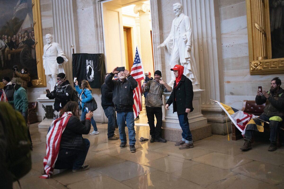 People who breached the U.S. Capitol gather in the building’s Rotunda in Washington, on Jan. 6, 2021. (Win McNamee/Getty Images)