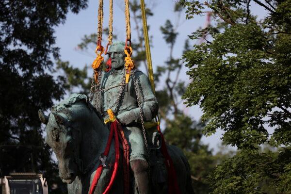 A statue of Confederate General Robert E. Lee, is removed after years of a legal battle over the contentious monument, in Charlottesville, Va., on July 10, 2021. (Evelyn Hockstein/Reuters)