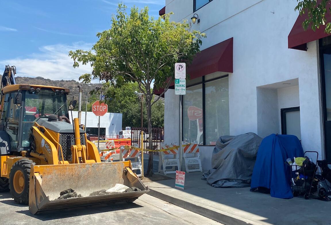 A construction project proceeds next to homeless tents in the Eagle Rock neighborhood of Los Angeles on July 29, 2021. (Jamie Joseph/The Epoch Times)