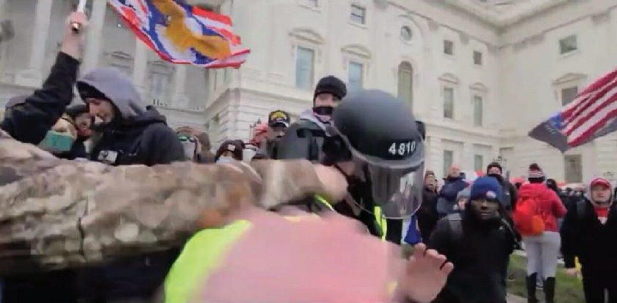 In this image from video, a man identified as Scott Fairlamb punches a Metropolitan Police Department officer outside the U.S. Capitol in Washington on Jan. 6, 2021. (FBI)