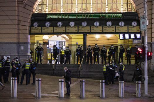 Police presence seen at Flinders Street Station during a proposed anti-lockdown protest in Melbourne, Australia, on Aug. 11, 2021. Regional Victoria's lockdown is over but people in Melbourne are still days from finding out when theirs will end. (AAP Image/Daniel Pockett)