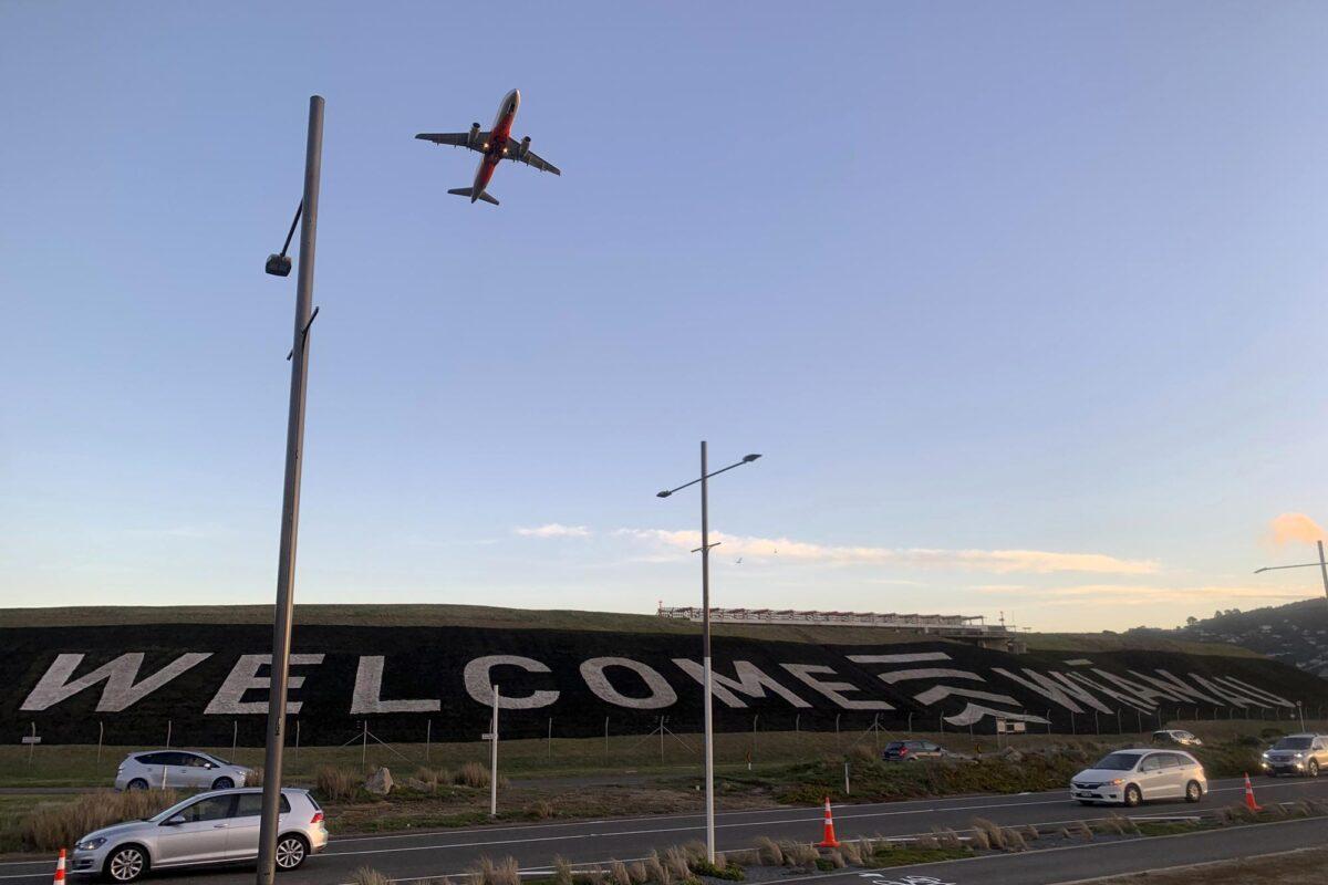 A giant sign painted near the main runway of the Wellington International Airport greets travelers returning home in Wellington, New Zealand on April 19, 2021. (Nick PerryAP Photo)
