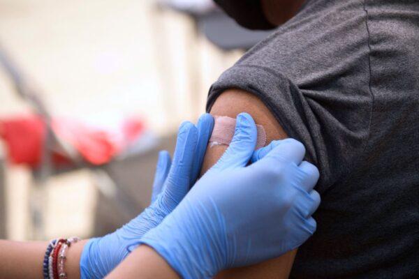 A person is bandaged after receiving the first dose of a COVID-19 vaccine at a mobile vaccination clinic at the Weingart East Los Angeles YMCA in Los Angeles, Calif., on Aug. 7, 2021. (Patrick T. Fallon/AFP via Getty Images)