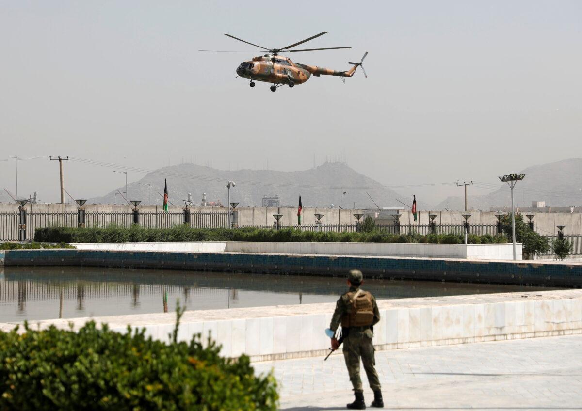 A military helicopter carrying Afghan President Ashraf Ghani prepares to land near the parliament in Kabul, Afghanistan on Aug. 2, 2021. (Stringer/Reuters)