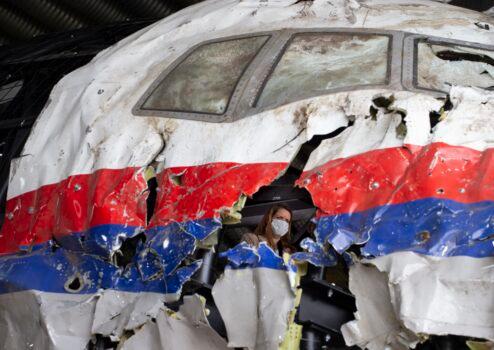 Trial judges and lawyers view the reconstructed wreckage of Malaysia Airlines Flight MH17, at the Gilze-Rijen military airbase, southern Netherlands, on May 26, 2021. (Peter Dejong/AP Photo)