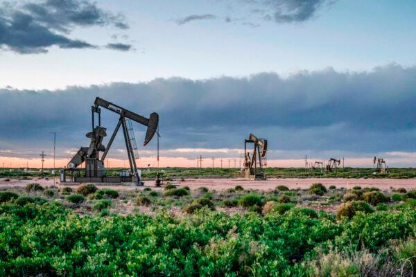 Pump jacks operate at dusk near Loco Hills in Eddy County, New Mexico, on April 23, 2020. (Paul Ratje/AFP via Getty Images)