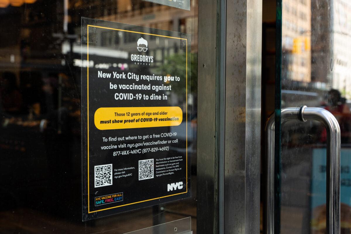 Vaccine proof requirement note displays at a restaurant storefront in New York on Sept. 7, 2021. (Chung I Ho/The Epoch Times)