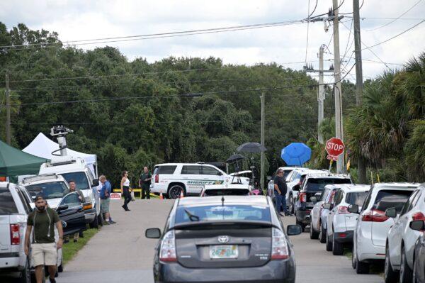 Vehicles from members of the media and curious passersby line a road outside the entrance of the Carlton Reserve during a search for Brian Laundrie, in Venice, Fla., on Sept. 21, 2021. (Phelan M. Ebenhack/AP Photo)