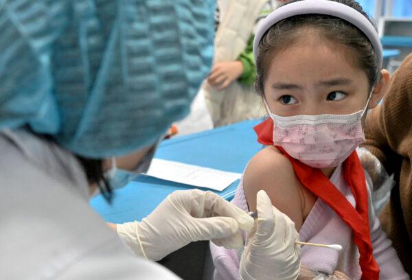 A child receives a COVID-19 coronavirus vaccine at a school in Handan in China's northern Hebei province, on Oct. 27, 2021. (AFP via Getty Images)