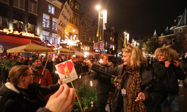 Protesters gather at Cafe del Mondo during demonstrations against COVID-19 measures in Amsterdam, on Nov. 20, 2021. (Eva Plevier/Reuters)