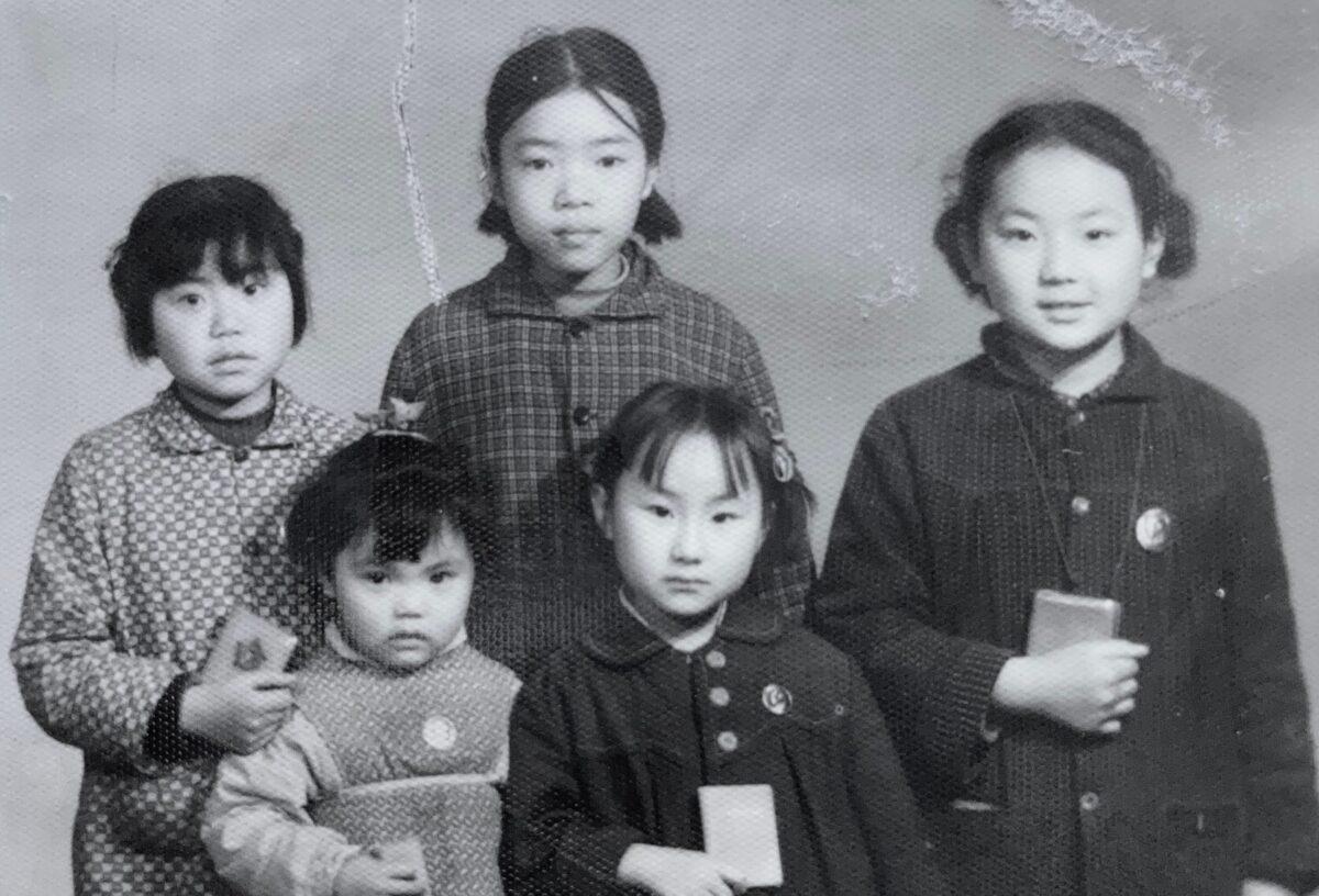 10-year-old Xi Van Fleet (R) and her friends hold the "little red book," also known as "Quotations from Chairman Mao Zedong," in 1969 during the Cultural Revolution. (Courtesy of Xi Van Fleet)