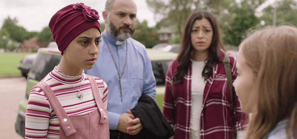(L–R) Theresa Cassillas (Stephanie Cood), Father Alonzo Alvarez (Ricardo Hinoa), Maria Casillas (Marisol Vera), and Sara Hopkins (Austyn Johnson). Theresa thanks Sara for curing her cancer, in "The Girl Who Believes in Miracles." (Gerson Productions)