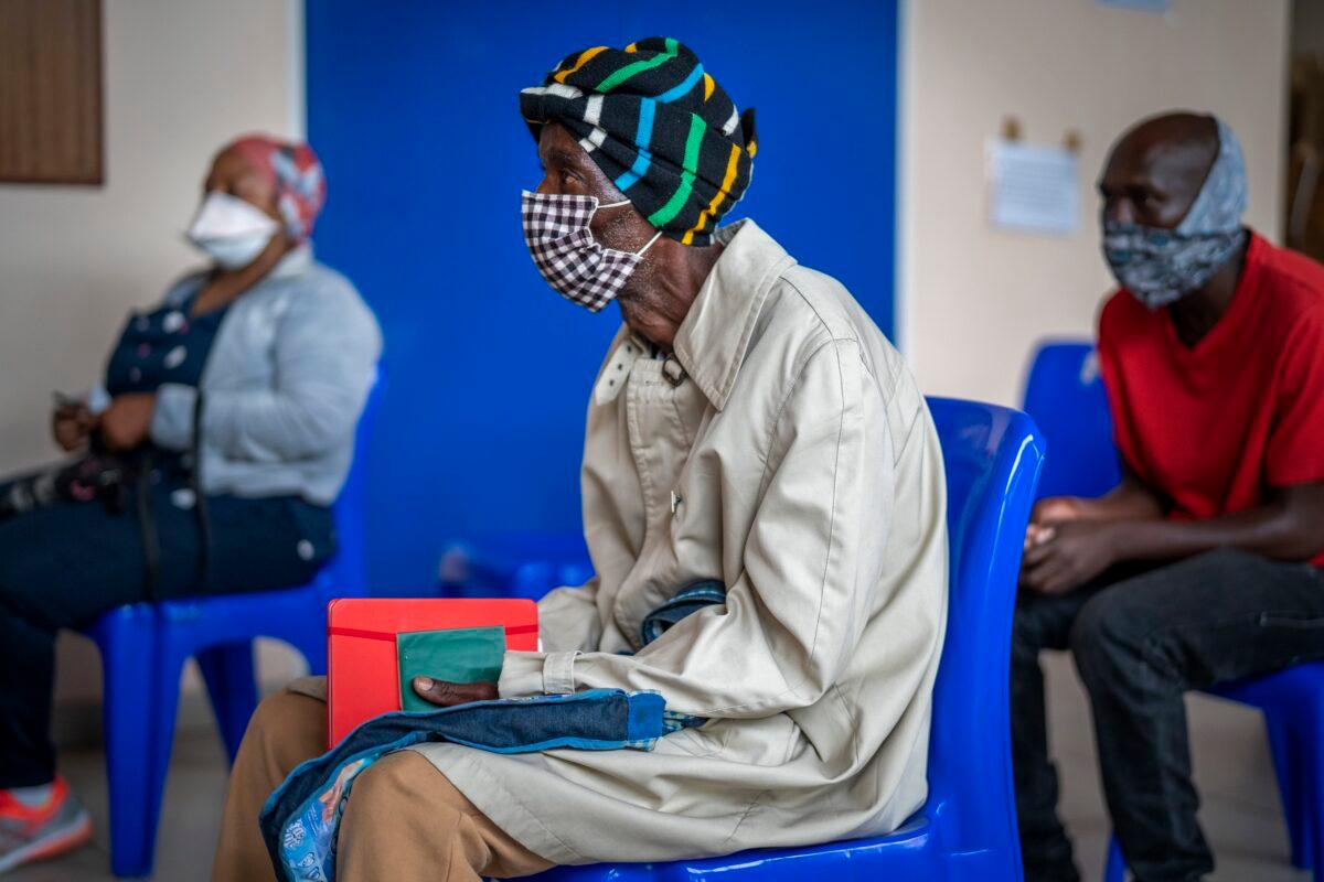 People wait for COVID-19 vaccination at Soweto's Baragwanath hospital in South Africa on Dec. 13, 2021. (Jerome Daley/AP Photo)