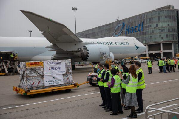 A trolley carrying Pfizer-BioNTech Comirnaty vaccine is transported to a warehouse after being unloaded from a Cathay Pacific cargo plane at Hong Kong International Airport in Hong Kong, on Feb. 27, 2021. (Jerome Favre - Pool/Getty Images)