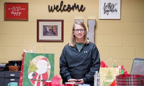 Hutsonville public school district superintendent Julie Kraemer stands in her office surrounded by holiday gifts from students and staff on the last school day before the holiday season on Dec. 17, 2021. (Cara Ding/The Epoch Times)