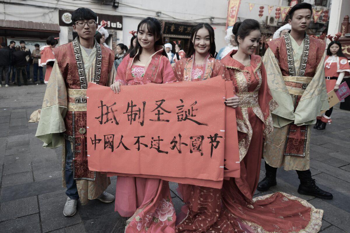 During an anti-Christmas street protest, university students wearing traditional Chinese outfits holding banners reading "Resist Christmas, Chinese people should not celebrate foreign festivals" in Changsha, central China's Hunan province on Dec. 24, 2014. (STR/AFP via Getty Images)