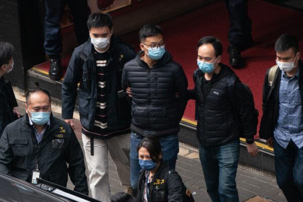 Stand News editor-in-chief Patrick Lam is brought into a vehicle after police searched the premises at the independent news outlet office in Hong Kong, on Dec. 29, 2021. (Anthony Kwan/Getty Images)