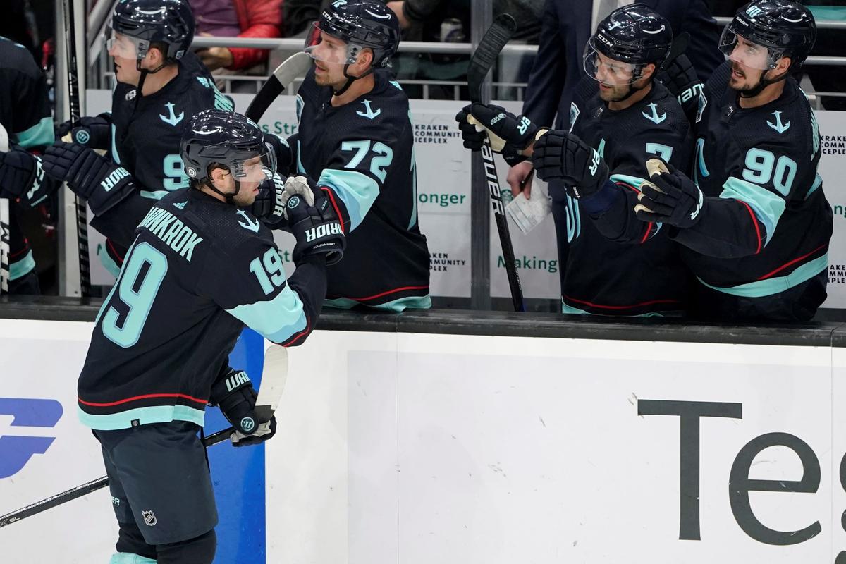 Seattle Kraken (C) Calle Jarnkrok (19) greets teammates after he scored a goal against the Vancouver Canucks during the second period of an NHL hockey game in Seattle, on Jan. 1, 2022. (Ted S. Warren/AP Photo)