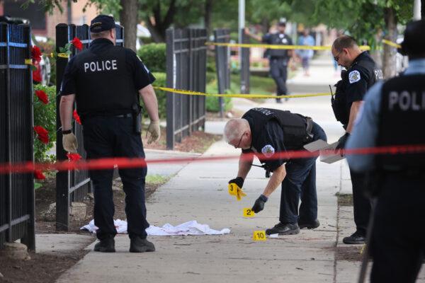 Police investigate a crime scene where three people were shot at the Wentworth Gardens housing complex in the Bridgeport neighborhood on June 23, 2021, in Chicago, Illinois. (Scott Olson/Getty Images)