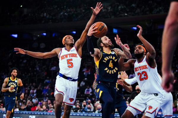 New York Knicks' Mitchell Robinson (23) and Immanuel Quickley (5) defend Indiana Pacers' Duane Washington Jr. (4) during the first half of an NBA basketball game, in New York City, on Jan. 4, 2022. (Frank Franklin II/AP Photo)
