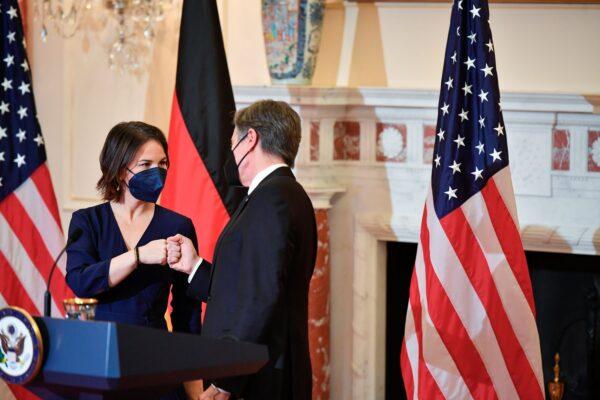 German Foreign Minister Annalena Baerbock fist bumps with Secretary of State Antony Blinken at the State Department in Wash., on Jan. 5, 2022. (Mandel Ngan/Pool via AP)