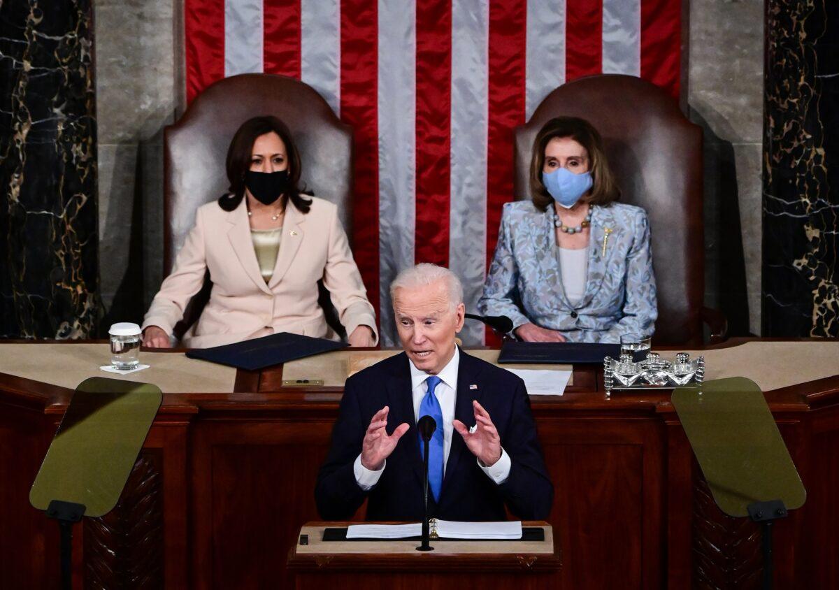 President Joe Biden addresses a joint session of Congress as Vice President Kamala Harris (L) and House Speaker Nancy Pelosi (D-Calif.) look on, in Washington on April 28, 2021. (Jim Watson/Pool/Getty Images)