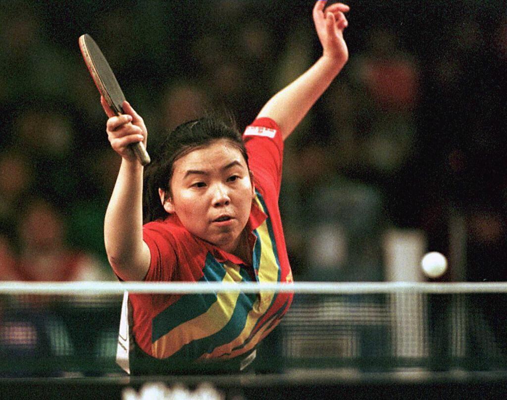 China's Den Yaping in action against South Korean Kim Hyon Hui (not pictured) during the women's team event at the World Table Tennis Championships in Manchester on April 29, 1997. (Bob Collier/AFP via Getty Images)