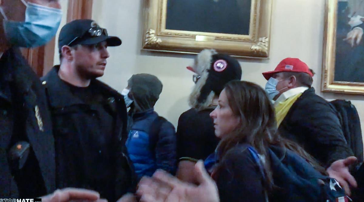 Ashli Babbitt shortly before she confronted Zachary Alam, seen wearing the fur-lined cap. Video shows Alam punched a window a short time later. (Tayler Hansen/Stop Hate–Rumble)