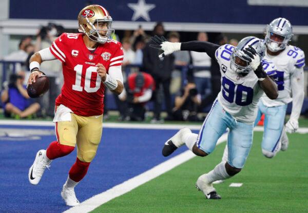 Jimmy Garoppolo #10 of the San Francisco 49ers scrambles against the Dallas Cowboys during the third quarter in the NFC Wild Card Playoff game at AT&T Stadium in Arlington, Texas, on Jan. 16, 2022. (Richard Rodriguez/Getty Images)