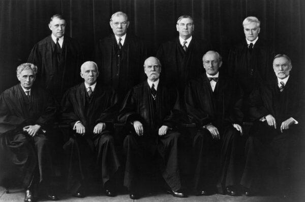 The members of the Supreme Court including Chief Justice Charles Evans Hughes (center, front row) who defied President Franklin D. Roosevelt's attempts to remove their veto by adding younger members more sympathetic to his liberal New Deal legislation to the court. (MPI/Getty Images)