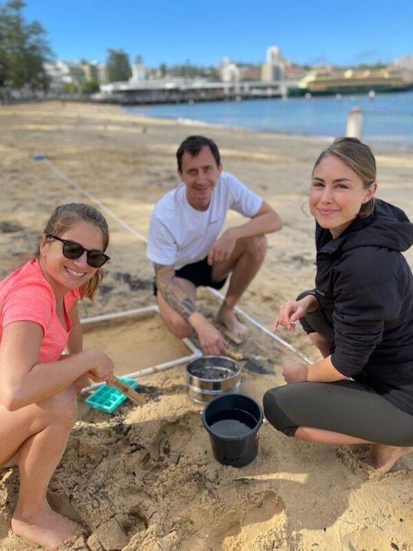 Collecting and recording microplastic involves setting out a square frame, scooping up the top few centimetres of sand within it, then sifting it. (AUSMAP/Supplied)