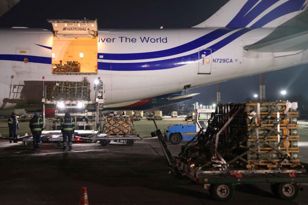 Ground crew unloads weapons and other military hardware delivered by the United States military at Boryspil Airport near Kyiv, Ukraine, on Jan. 25, 2022. (Sean Gallup/Getty Images)