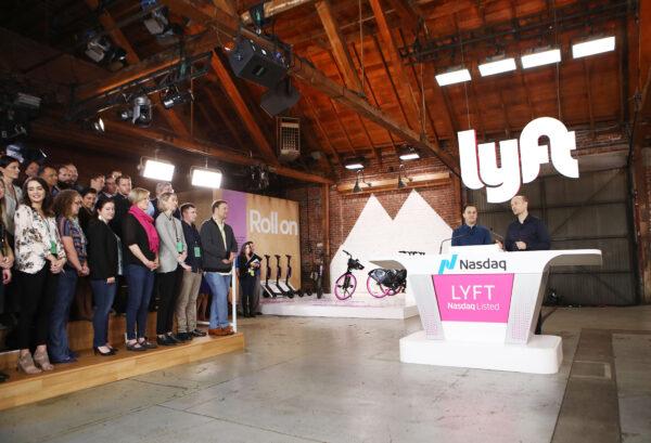 Lyft CEO Logan Green (R) and President John Zimmer (2nd R) speak before the Nasdaq opening bell celebrating the company's initial public offering (IPO) in Los Angeles, on March 29, 2019. (Mario Tama/Getty Images)