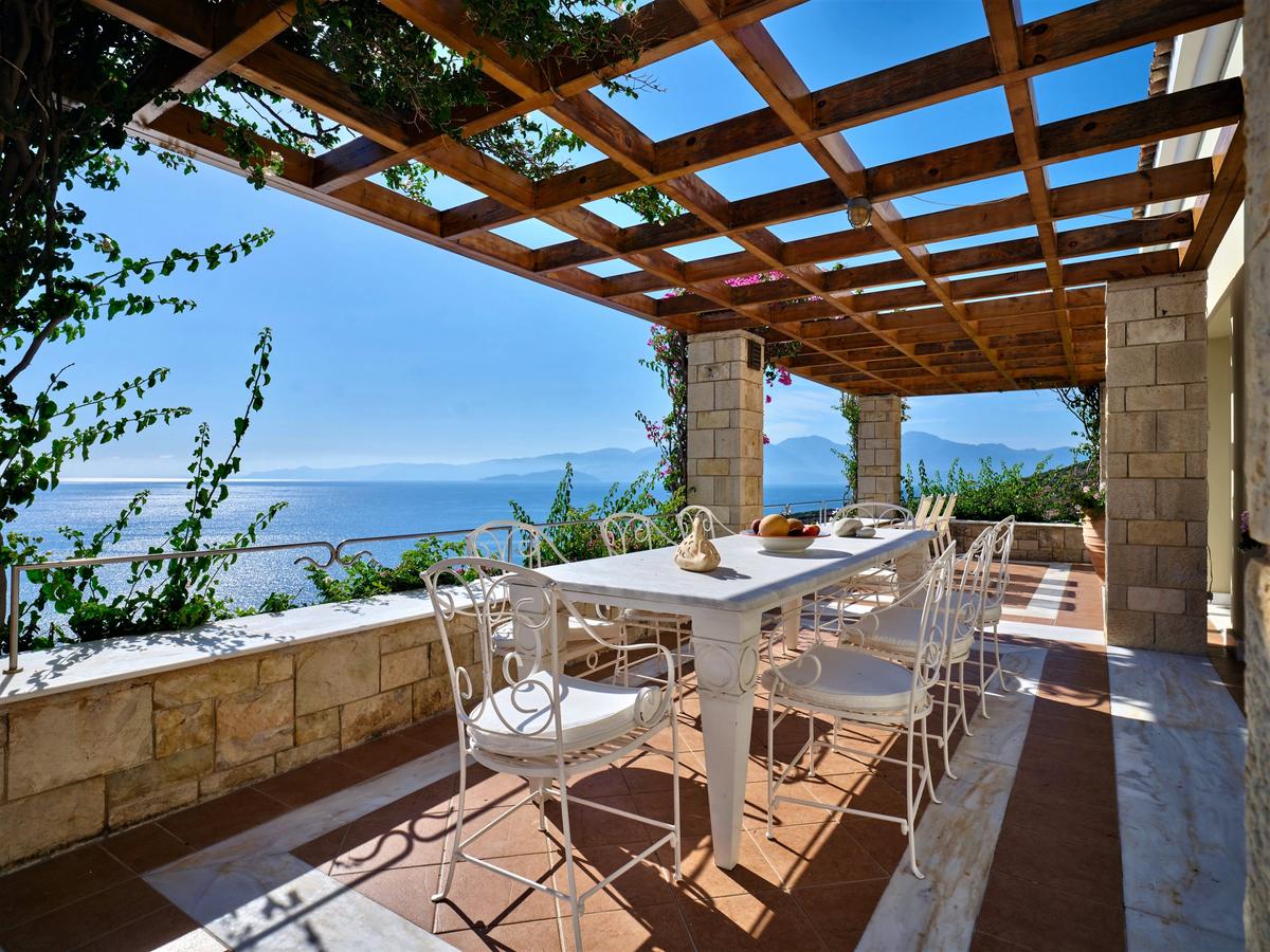 Outside, there are entertainment, dining, and activity areas galore. A barbecue area, dining areas, walking paths, sunning areas, and the pool area offer almost unlimited experiential possibilities. (Courtesy of Greece Sotheby's International Realty)