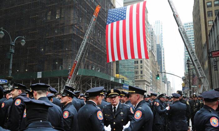 A sea of blue uniforms stretched at least seven city blocks in New York during slain office Jason Rivera's funeral at St Patrick's Cathedral on Jan. 28, 2022. (Richard Moore/The Epoch Times)