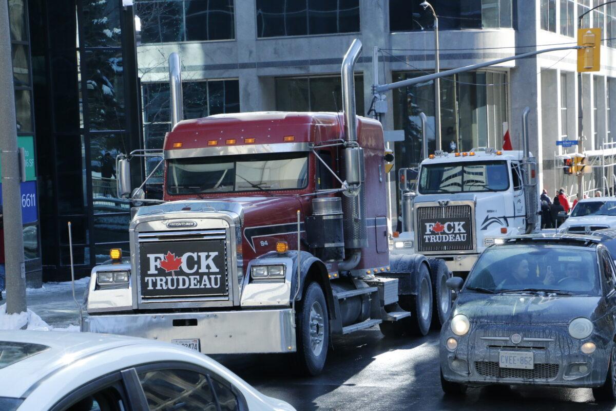 Trucks part of the "Freedom Convoy" ride through downtown Ottawa, Canada, on Jan. 29, 2022. (Noé Chartier/The Epoch Times)