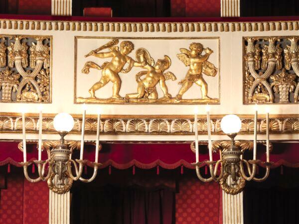 Globe candelabras illuminate the gold-leafed cherubs depicted on the paneling. (Luciano Romano/Teatro di San Carlo)