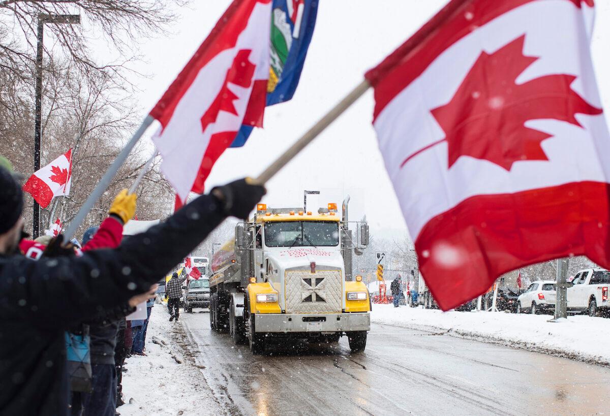 People gather in protest against COVID-19 mandates and in support of a protest against COVID-19 restrictions taking place in Ottawa, in Edmonton, Canada, on Feb. 5, 2022. (Jason Franson/The Canadian Press via AP)
