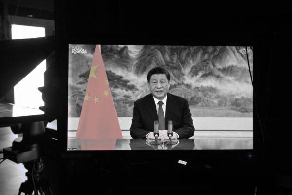 Chinese leader Xi Jinping is seen on a TV screen speaking remotely at the opening of the World Economic Forum's Davos Agenda virtual sessions at the WEF's headquarters in Cologny near Geneva, on Jan. 17, 2022. (Fabrice Coffrini/AFP via Getty Images)