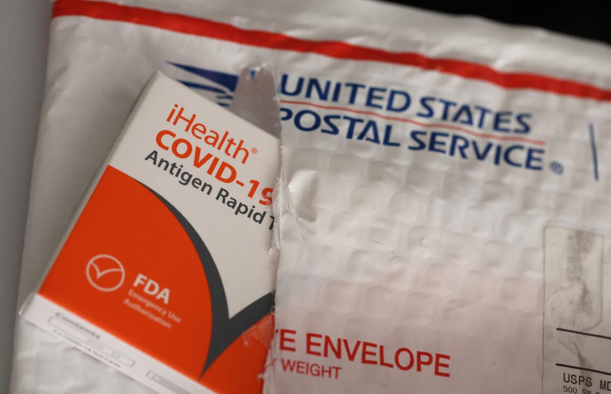 In this photo illustration, free iHealth COVID-19 antigen rapid tests from the federal government sit on a U.S. Postal Service envelope after being delivered in San Anselmo, Calif., on on Feb. 04, 2022. (Photo Illustration by Justin Sullivan/Getty Images)