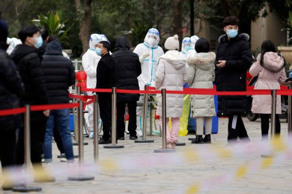 People queue to give a sample for nucleic acid testing for COVID-19 in Suzhou, Jiangsu Province, China, on February 16, 2022. (STR/AFP via Getty Images)